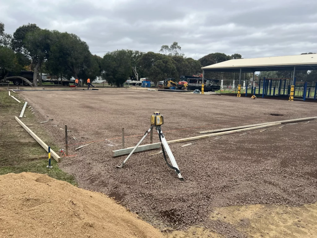 Laser grading setup for precise leveling of a sports court base.