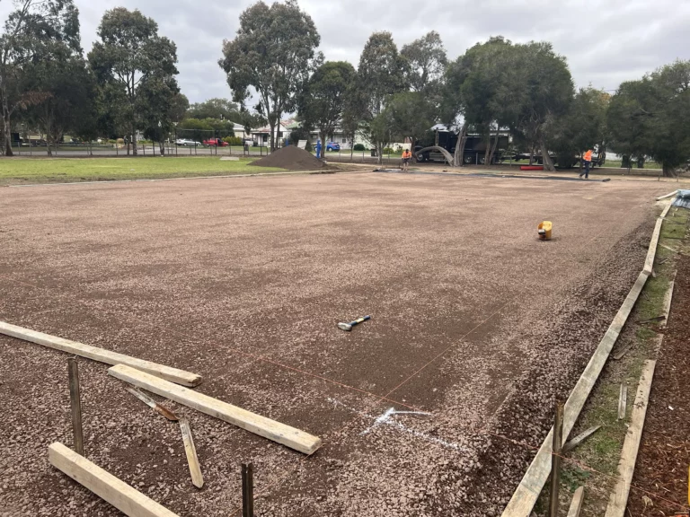 Image of the sports court site being prepared with crushed rock before concrete pouring.