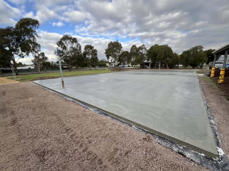 Freshly poured concrete base for a sports court under a partly cloudy sky at a Ballarat primary school.