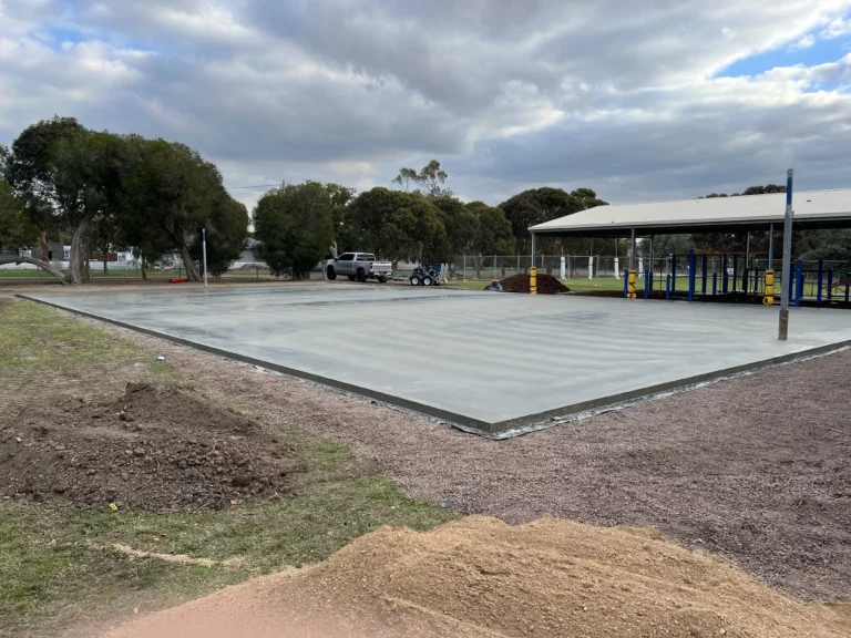 Freshly poured concrete base for the sports court at a primary school.