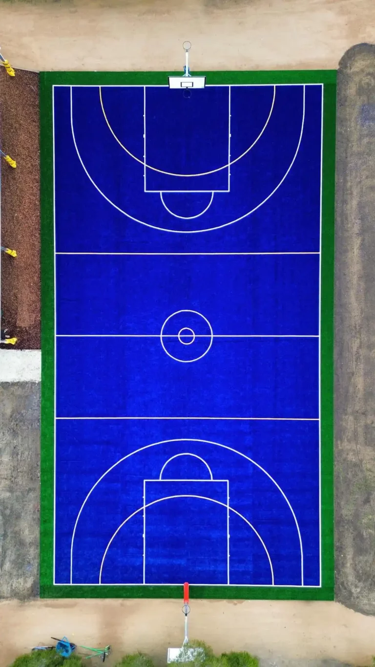 Fully constructed sports court with synthetic grass, ready for use at a primary school.