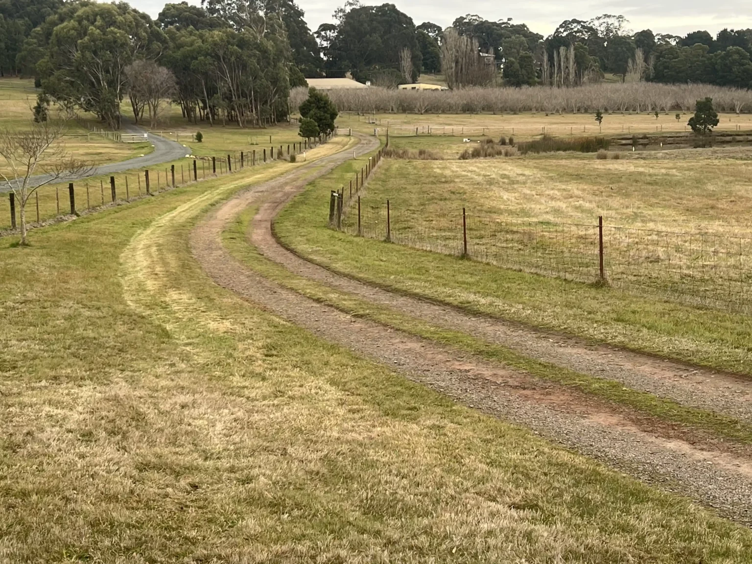 Gravel driveway before resurfacing in Ballarat with uneven terrain.